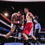 A dynamic scene of two boxers in action during a fierce match in the boxing ring.